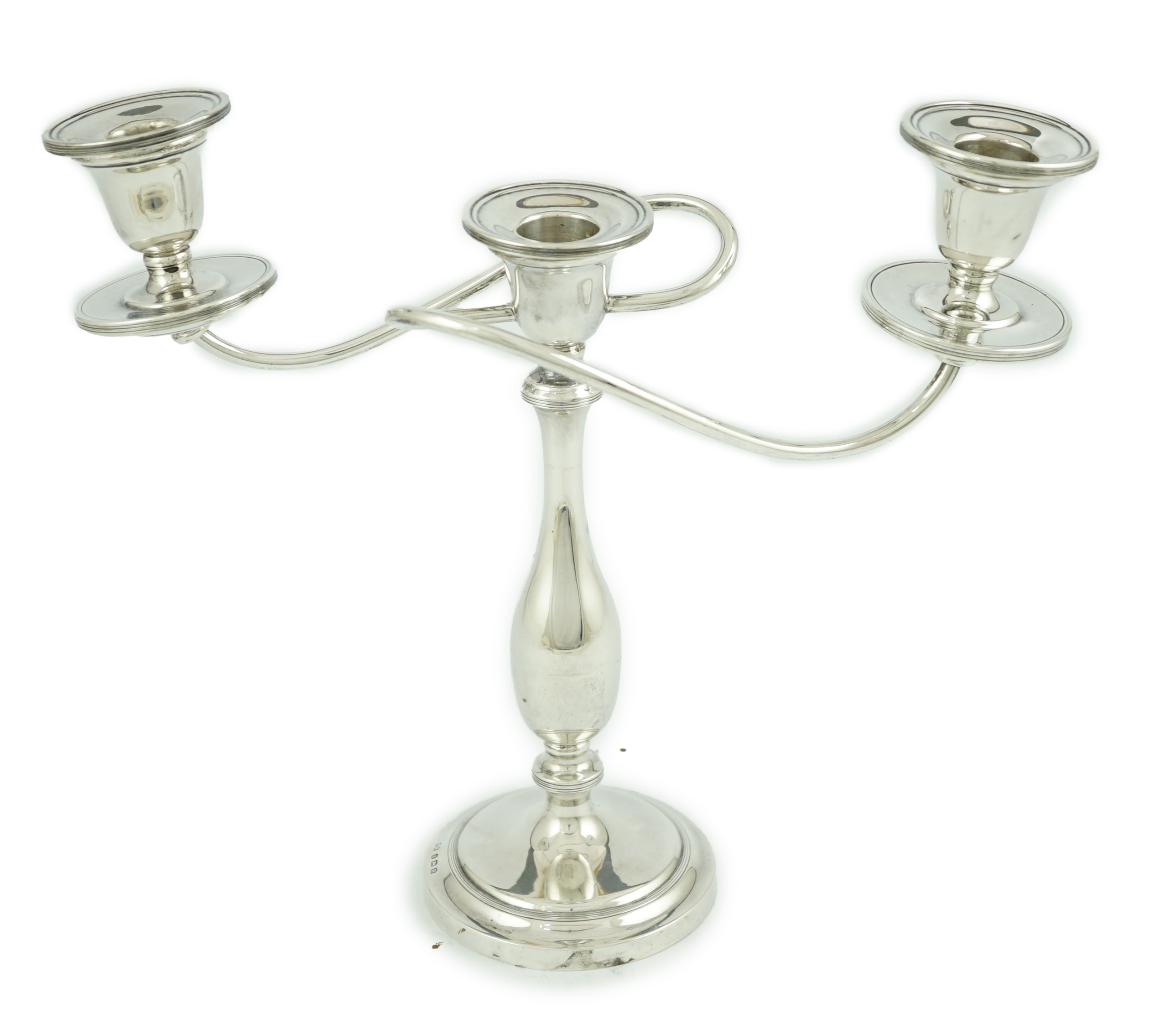 A George VI silver two branch, three light candelabrum, by William Adams Ltd, Birmingham, 1937, height 24cm, 13.7oz. Condition - poor to fair